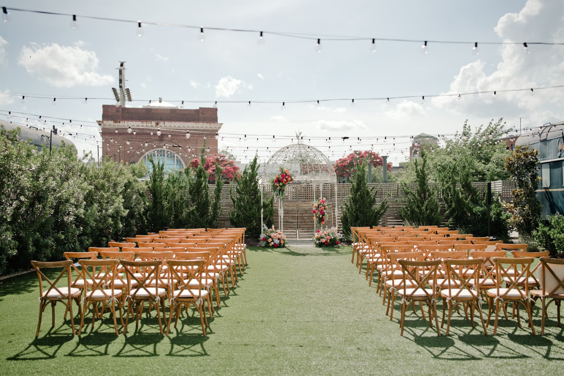 A ceremony arbor with florals and string lights